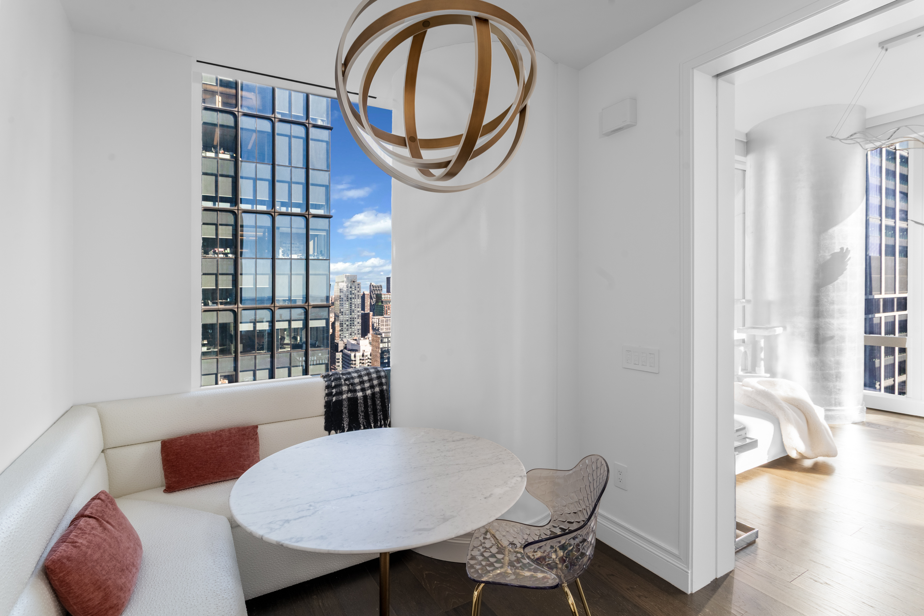 35 Hudson Yards, Unit 5903 Manhattan, NY 10001 - Photo 5 of 15 a view of a dining room with furniture and a large window