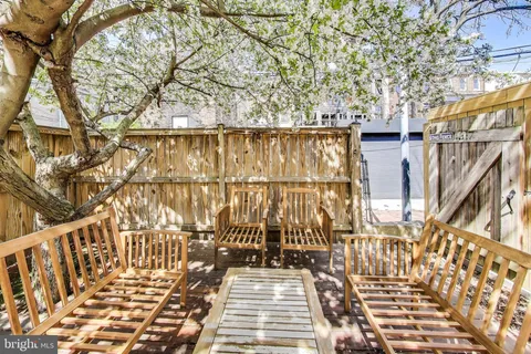 a view of a balcony with wooden floor and fence