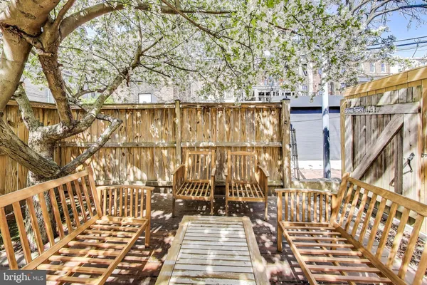 a view of a balcony with wooden floor and fence