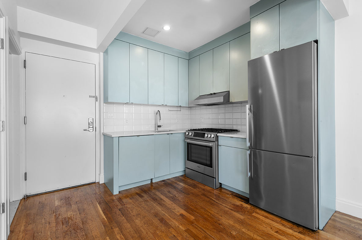 686 MacDonough Street, Unit 2A Brooklyn, NY 11233 - Photo 4 of 8 a kitchen with a refrigerator and a stove top oven