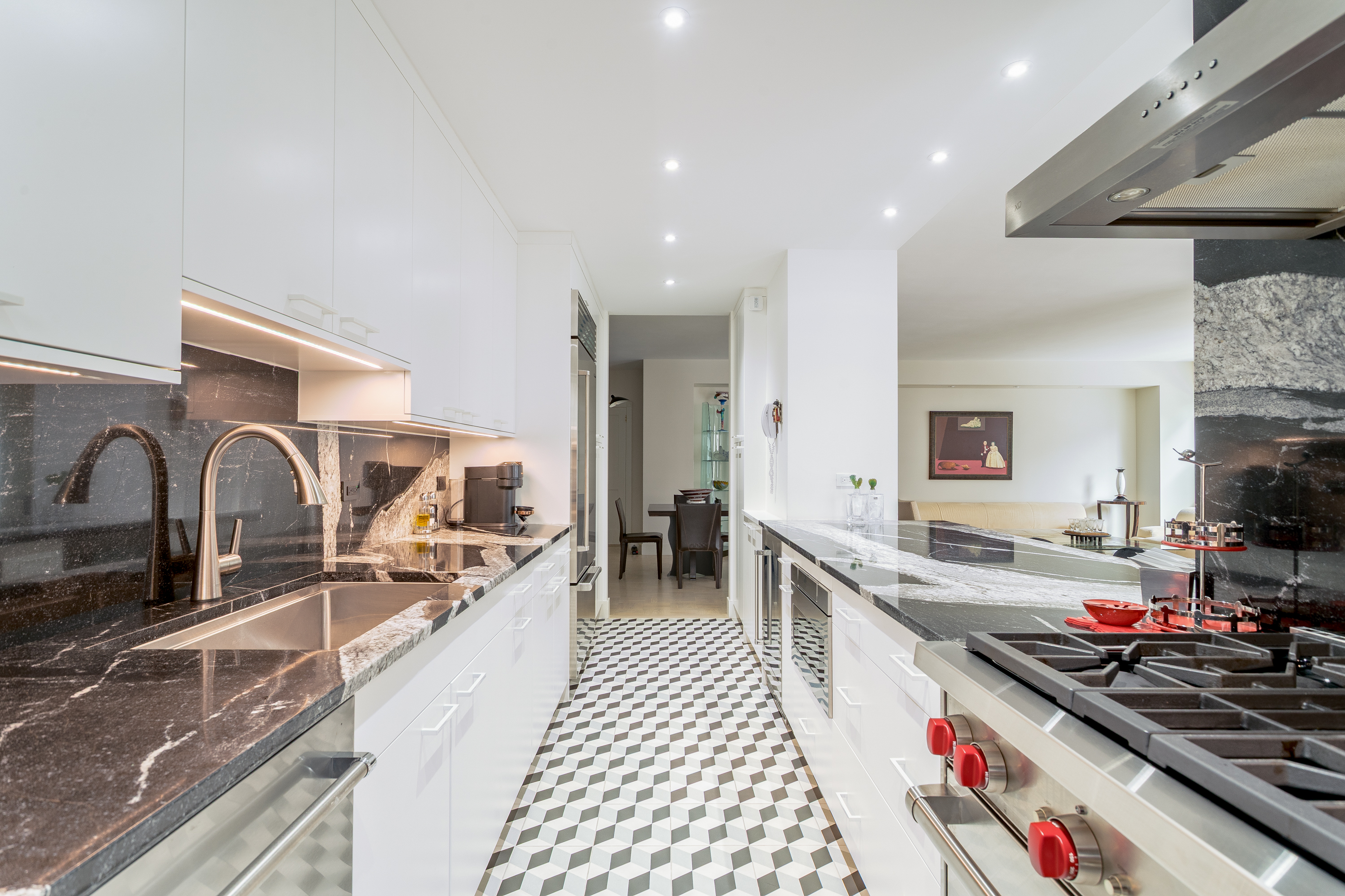 150 East 69th Street, Unit 5C Manhattan, NY 10021 - Photo 4 of 15 a kitchen with lots of counter top space a stove a sink and a refrigerator