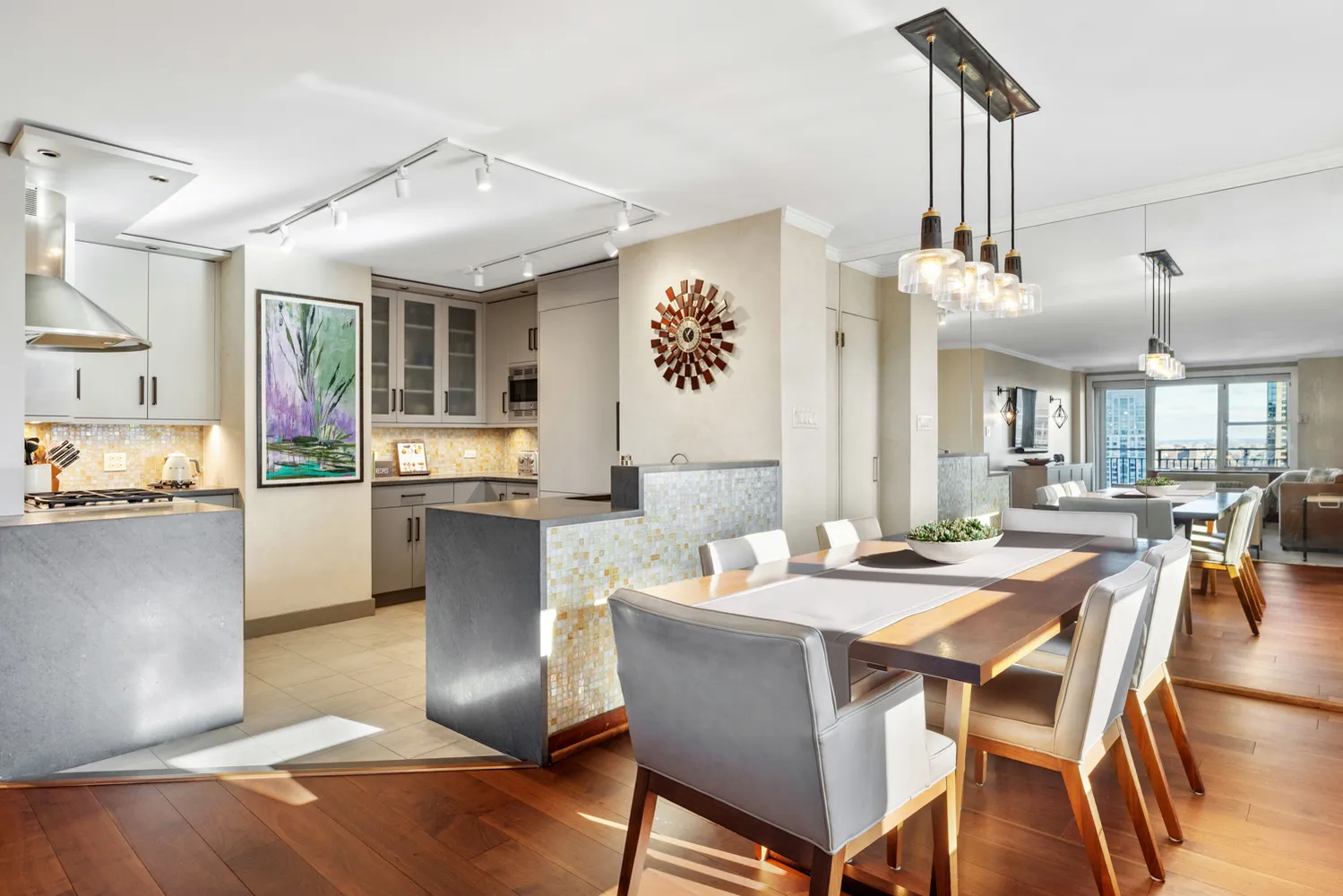 a dining area with a table chairs and a kitchen view