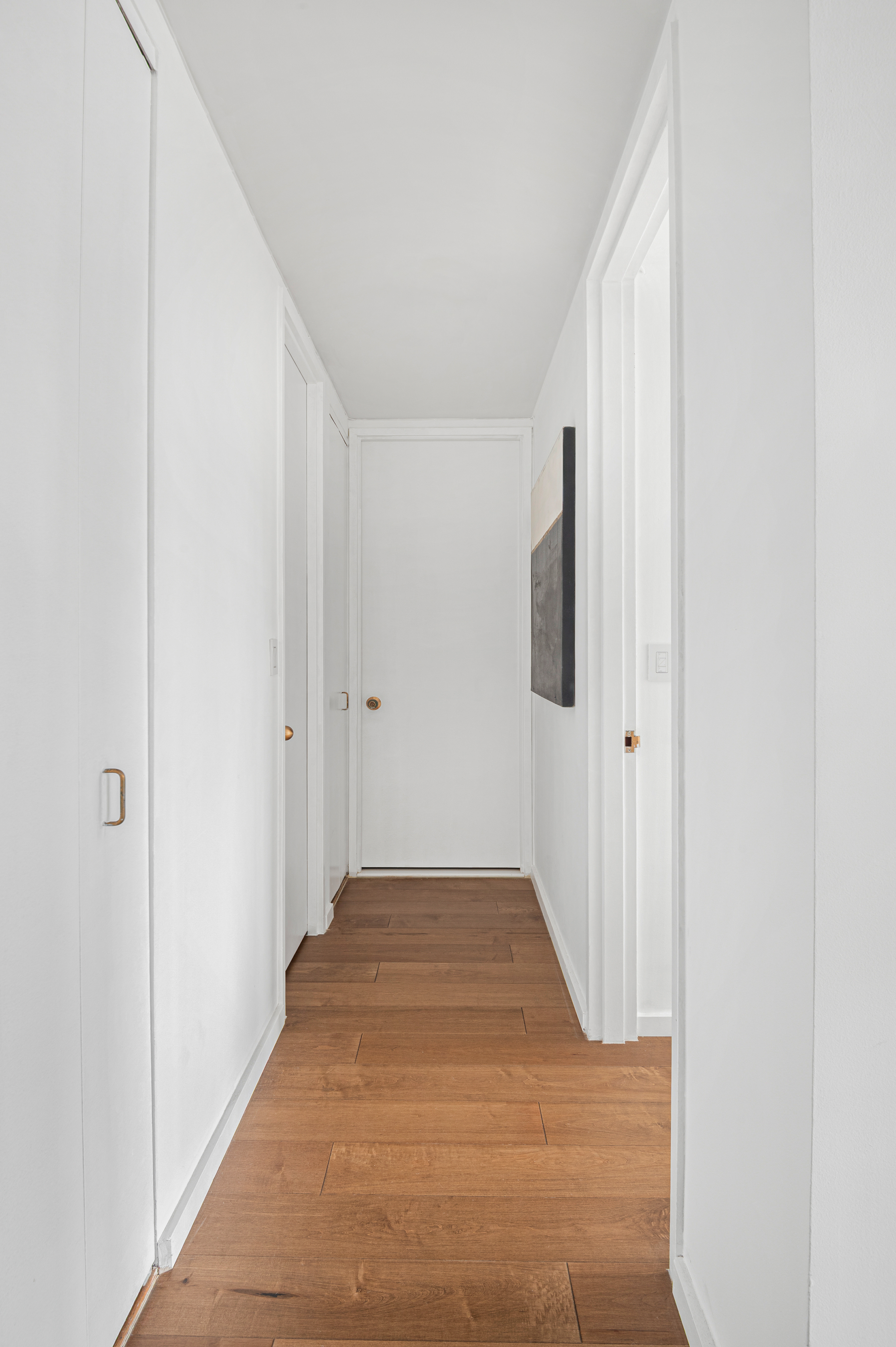 350 West 50th Street, Unit 29D Manhattan, NY 10019 - Photo 6 of 14 a view of a hallway with wooden floor and staircase