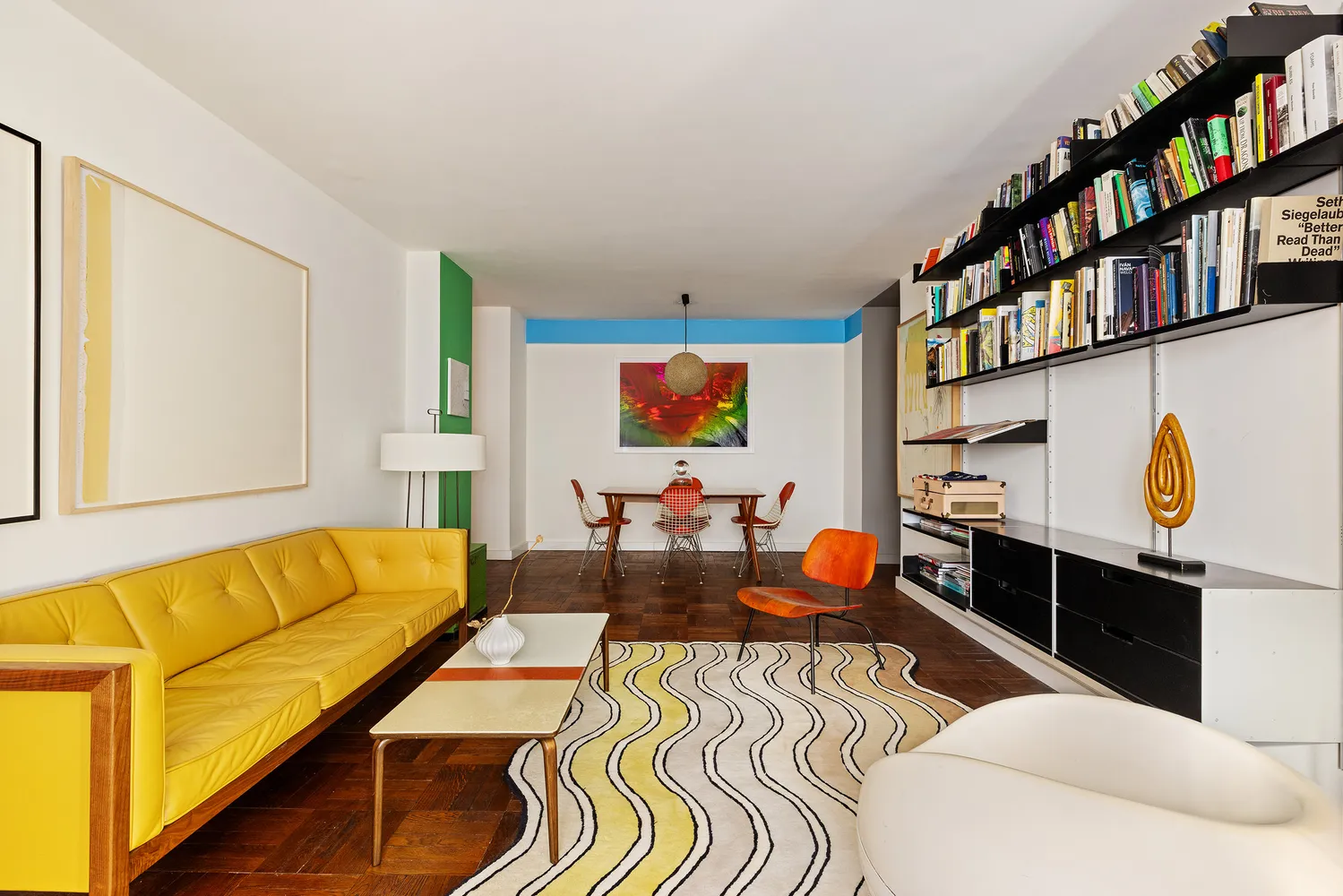 a living room with furniture gym equipment and a window