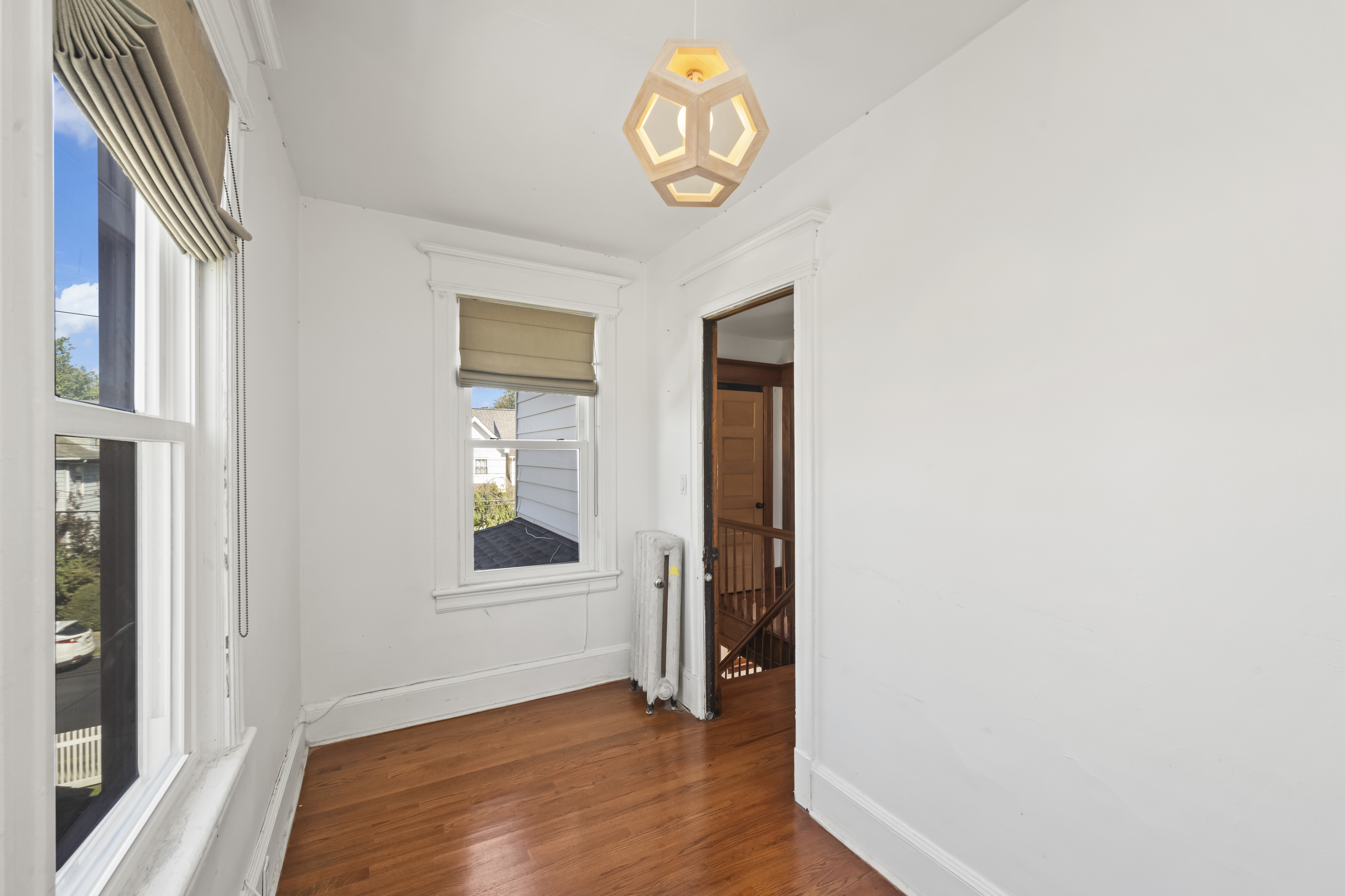 704 Delafield Avenue Staten Island, NY 10310 - Photo 19 of 35 a view of an empty room with wooden floor and a window