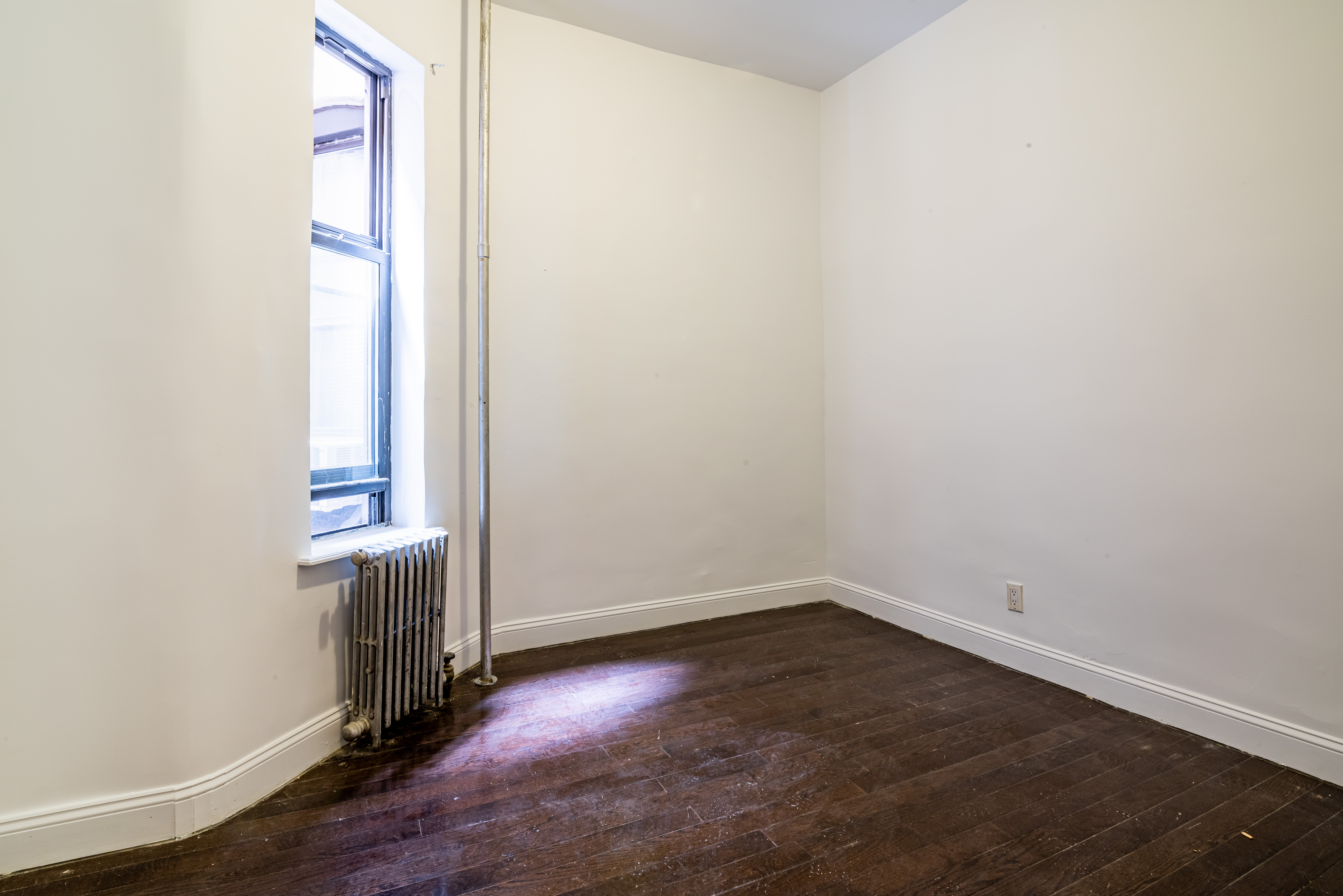 681 Sterling Place, Unit 2L Brooklyn, NY 11216 - Photo 5 of 8 an empty room with wooden floor and a window