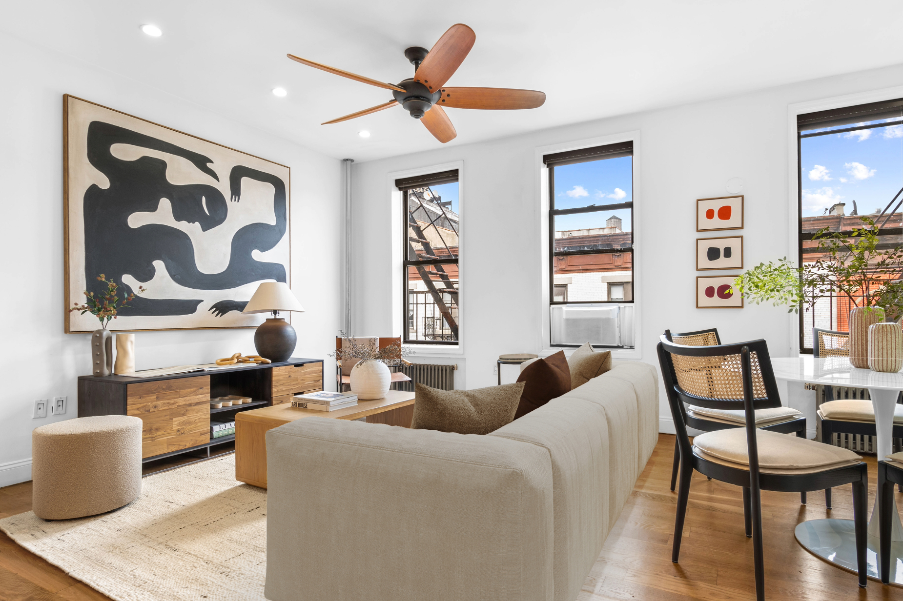 131 Thompson Street, Unit 6F Manhattan, NY 10012 - Photo 2 of 9 a living room with furniture and paintings on the wall
