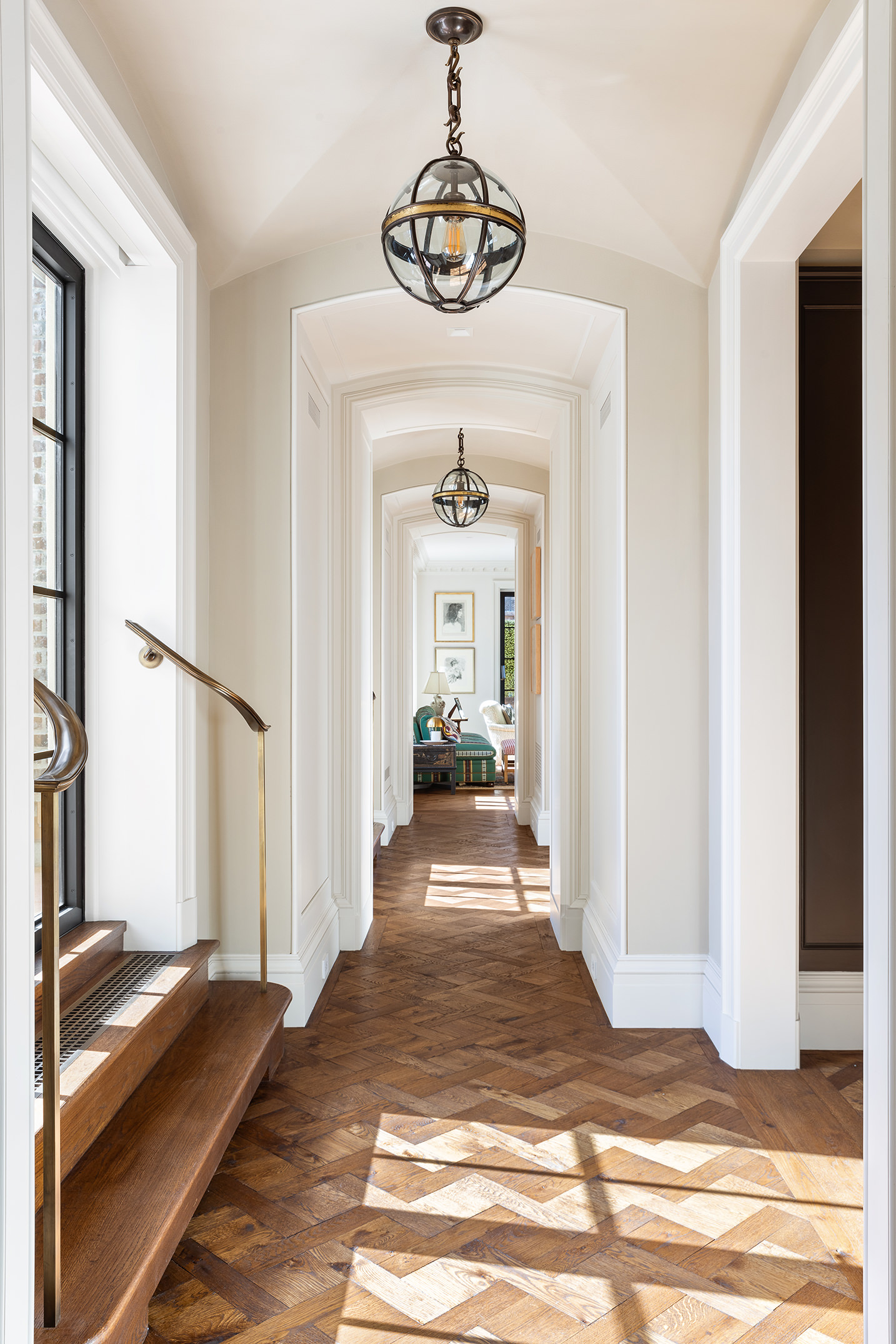 150 East 73rd Street, Unit PH Manhattan, NY 10021 - Photo 2 of 29 a view of a hallway to a livingroom with wooden floor and a chandelier