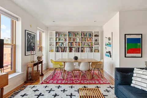 a living room with furniture and a rug