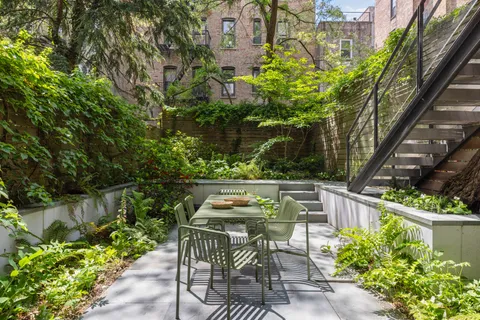 a view of a chairs and a table in the patio