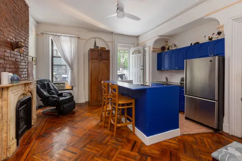 a kitchen with stainless steel appliances granite countertop a refrigerator stove and sink