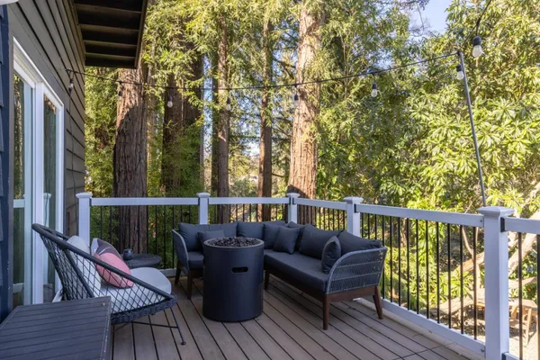 a balcony with wooden floor and outdoor seating
