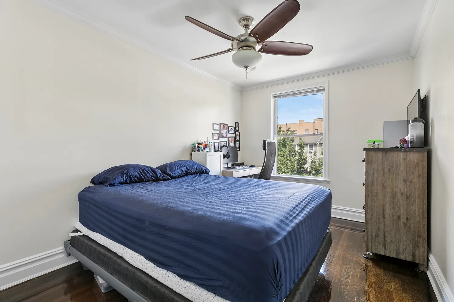 a bed sitting in a spacious bedroom next to a window