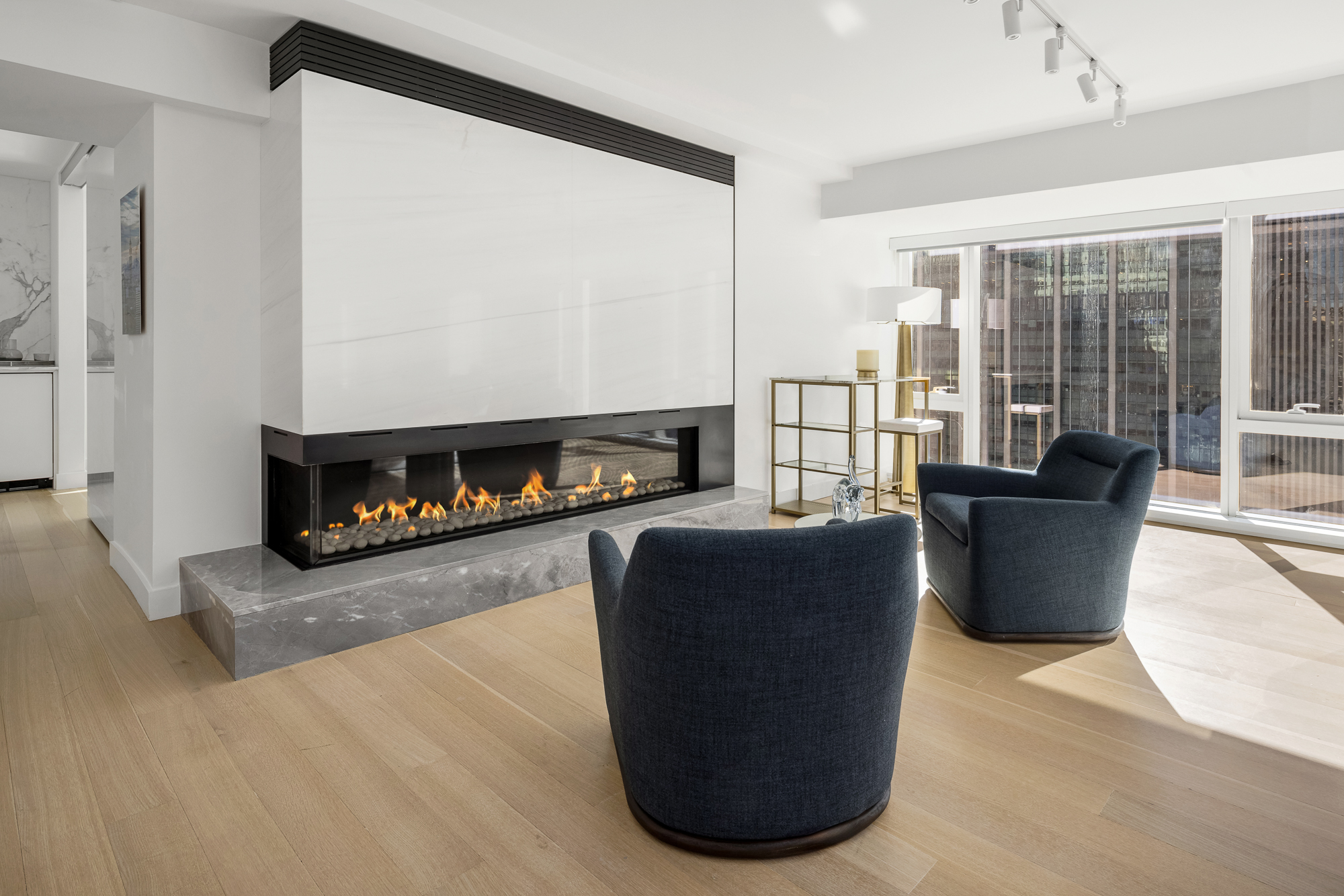 135 West 52nd Street, Unit 40A Manhattan, NY 10019 - Photo 4 of 24 a living room with furniture and a fireplace