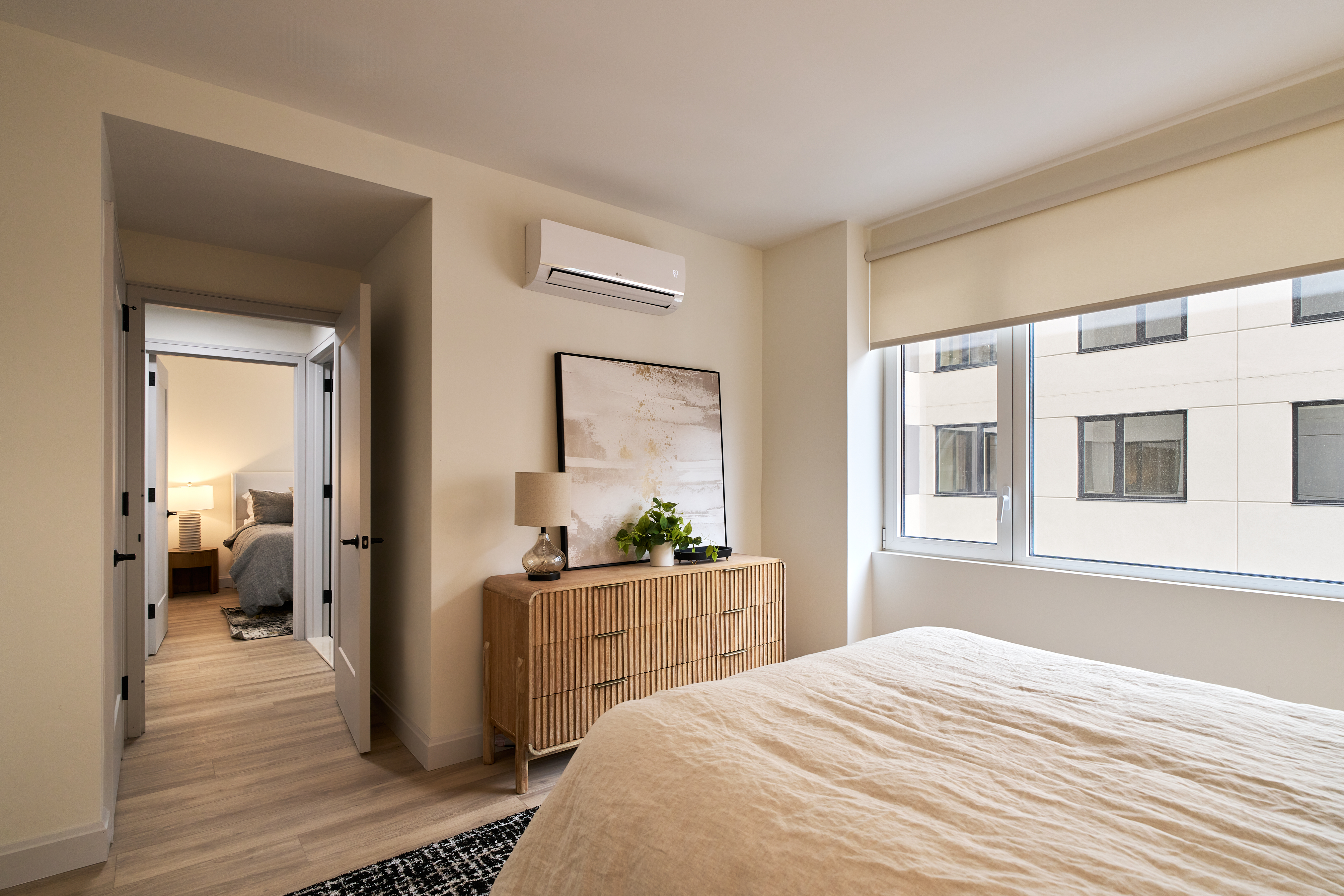 4414 Douglaston Parkway, Unit 6C Queens, NY 11363 - Photo 4 of 14 a bedroom with a bed and a large window