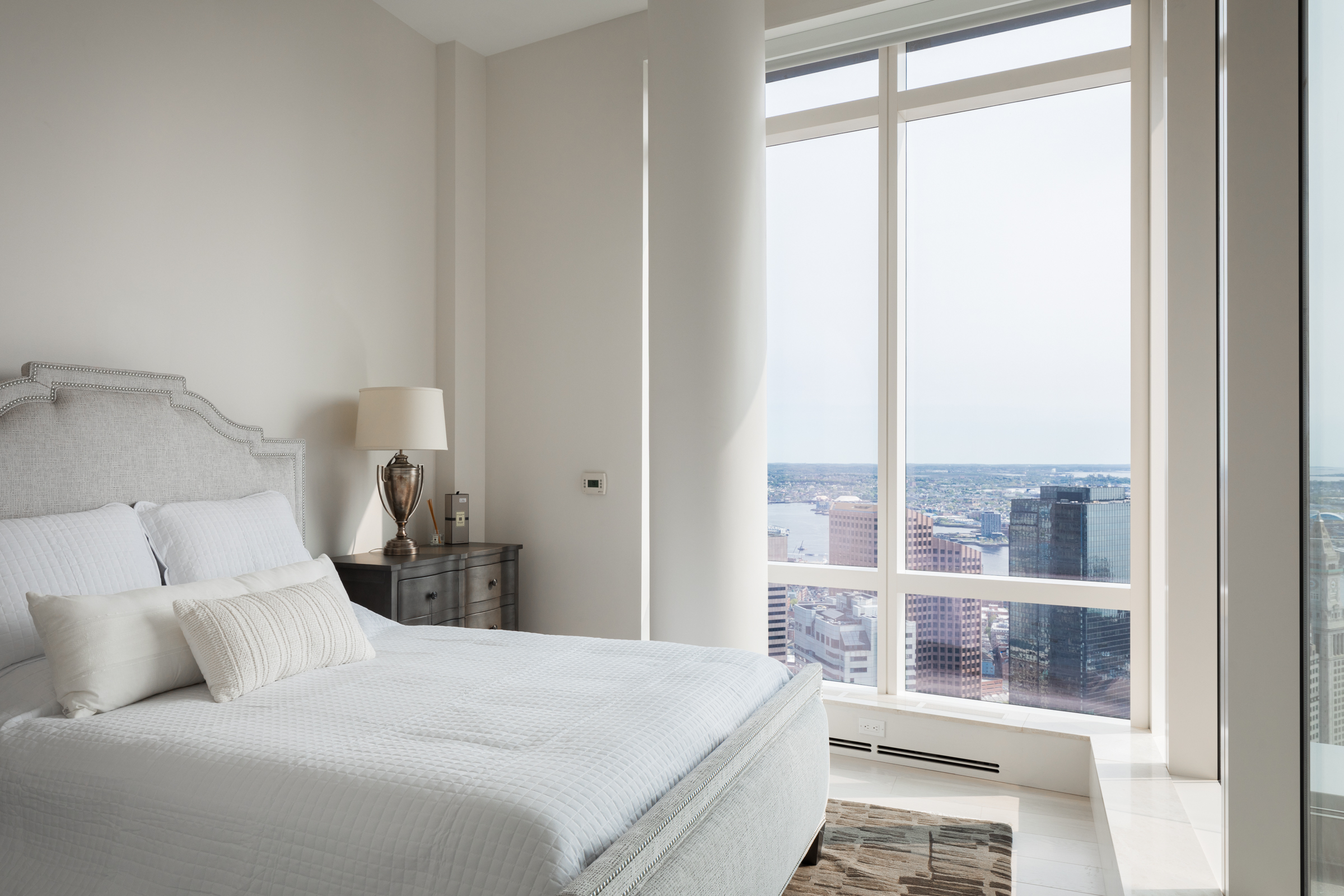 1 Franklin Street, Unit PH2D Boston, MA 02110 - Photo 23 of 26 a bedroom with a large bed and a large window
