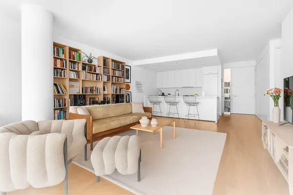 a living room with furniture and a book shelf
