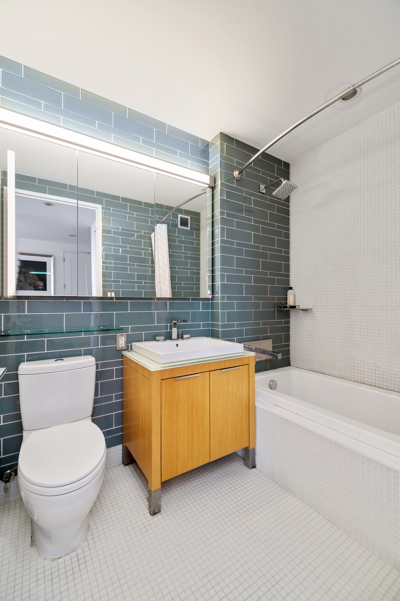 22 North 6th Street, Unit 18D Brooklyn, NY 11249 - Photo 7 of 9 a bathroom with a sink a toilet and bathtub