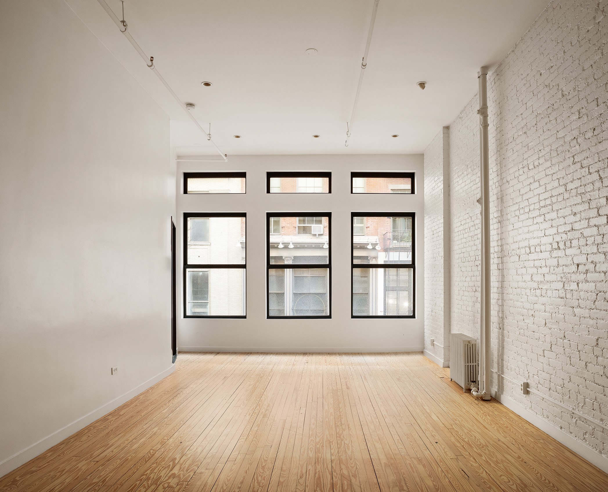 169 Mercer Street, Unit 2 Manhattan, NY 10012 - Photo 4 of 10 wooden floor in an empty room
