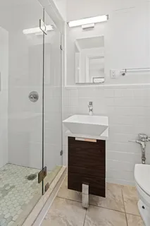 a bathroom with a sink a toilet and a mirror