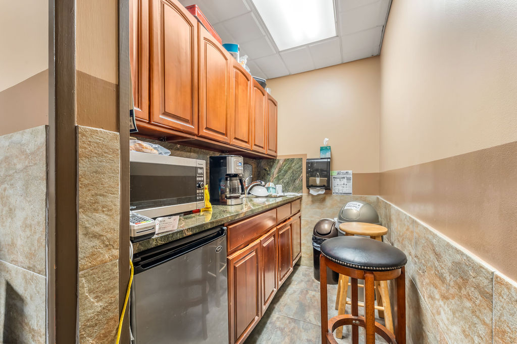869 Bergen Avenue, Unit COMMERCIAL Jersey City, NJ 07306 - Photo 9 of 26 a kitchen with stainless steel appliances granite countertop a sink and a stove