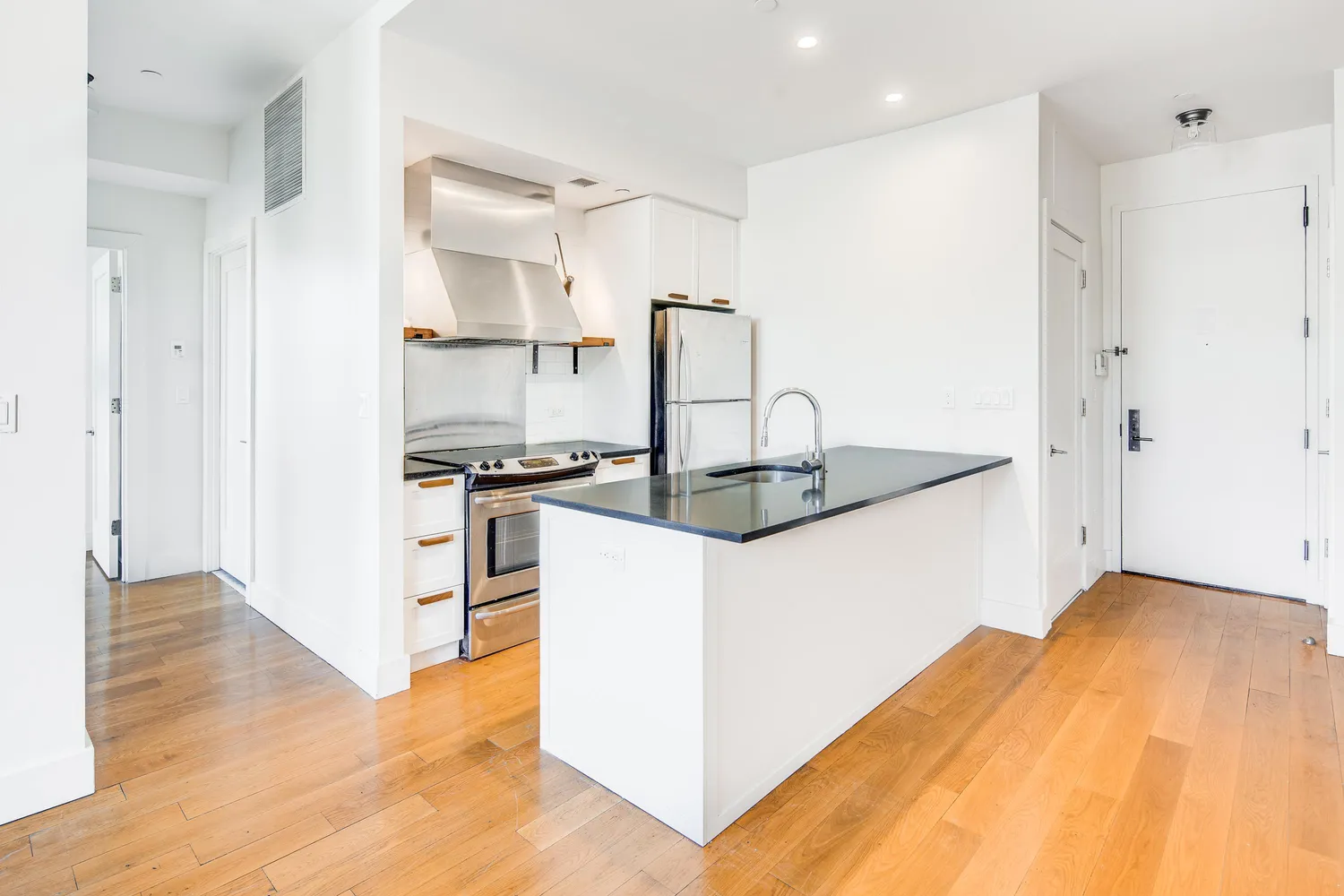 a kitchen with kitchen island a counter top space and cabinets