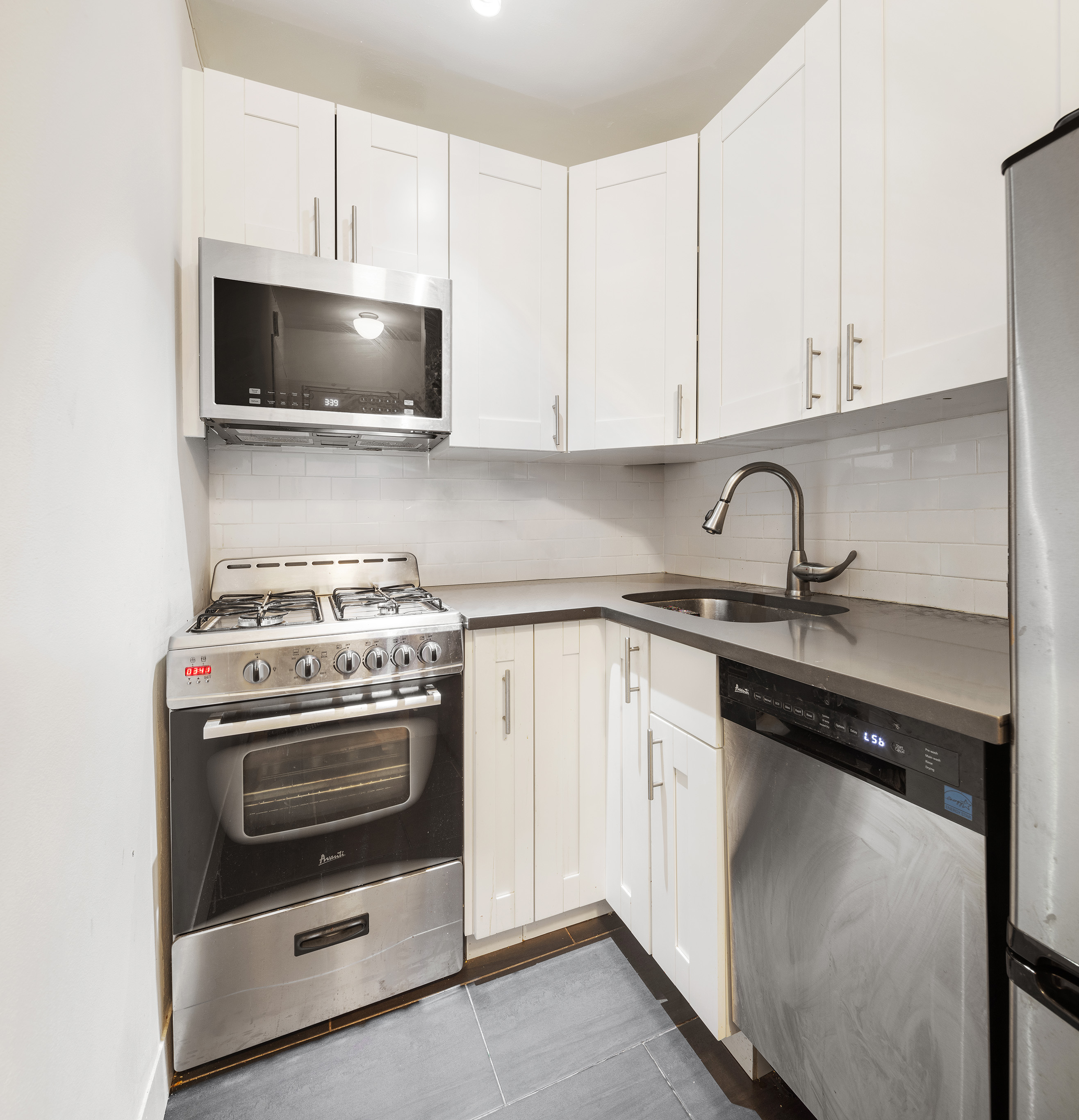 175 West 12th Street, Unit 5M Manhattan, NY 10011 - Photo 8 of 10 a kitchen with a stove and a microwave