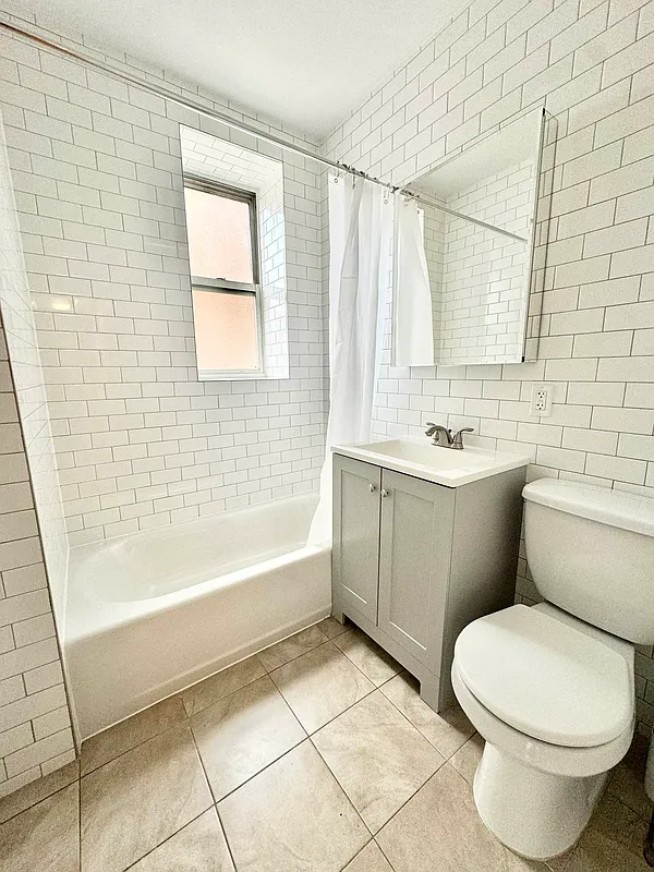 2022 Beverley Road, Unit 3 Brooklyn, NY 11226 - Photo 7 of 11 a bathroom with a sink a toilet and bathtub