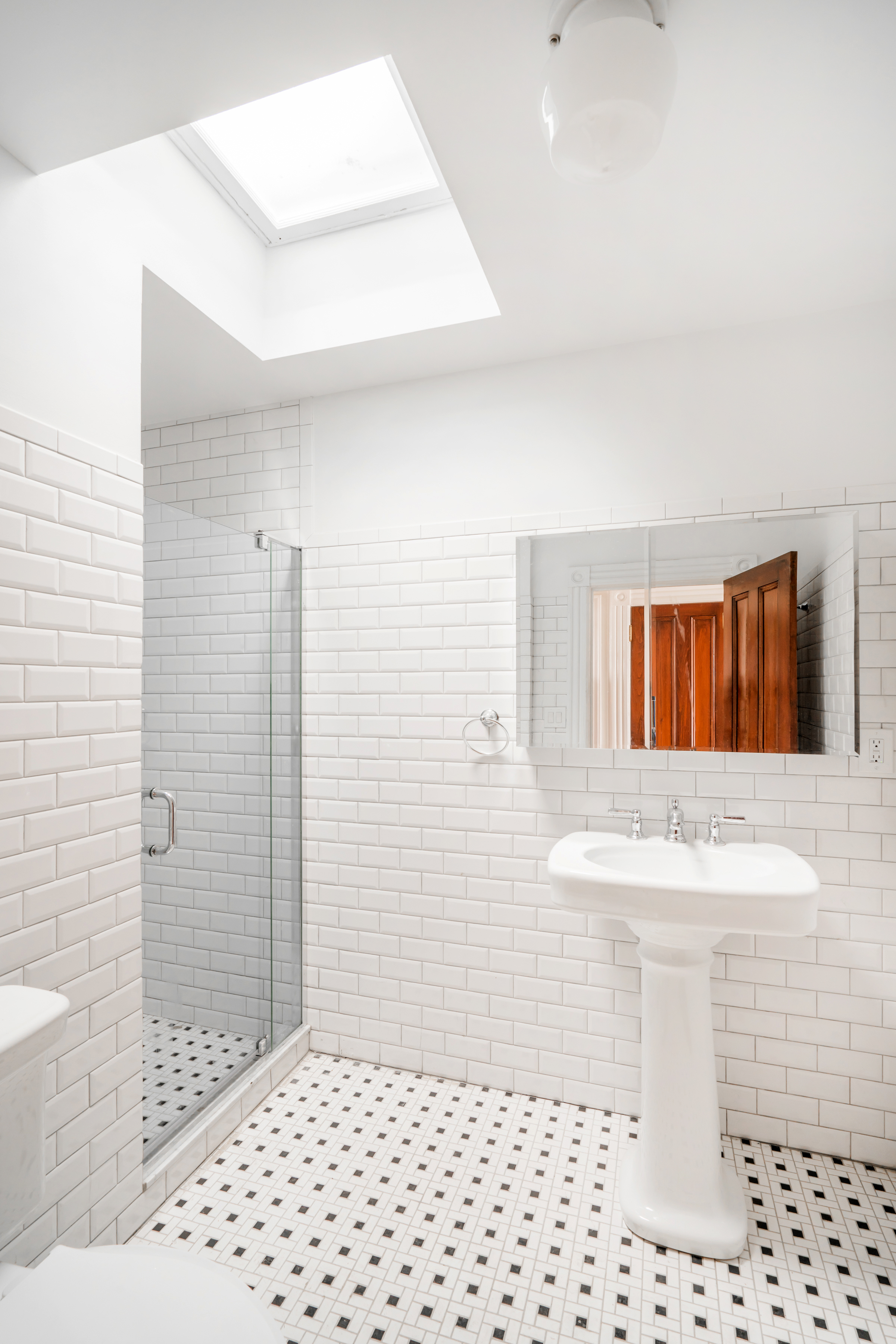 670 Macon Street, Unit 2 Brooklyn, NY 11233 - Photo 13 of 16 a bathroom with a sink a toilet and shower