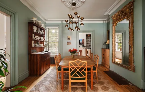a view of a dining room with furniture and a chandelier