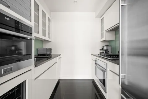 a kitchen with stainless steel appliances granite countertop a stove and a refrigerator