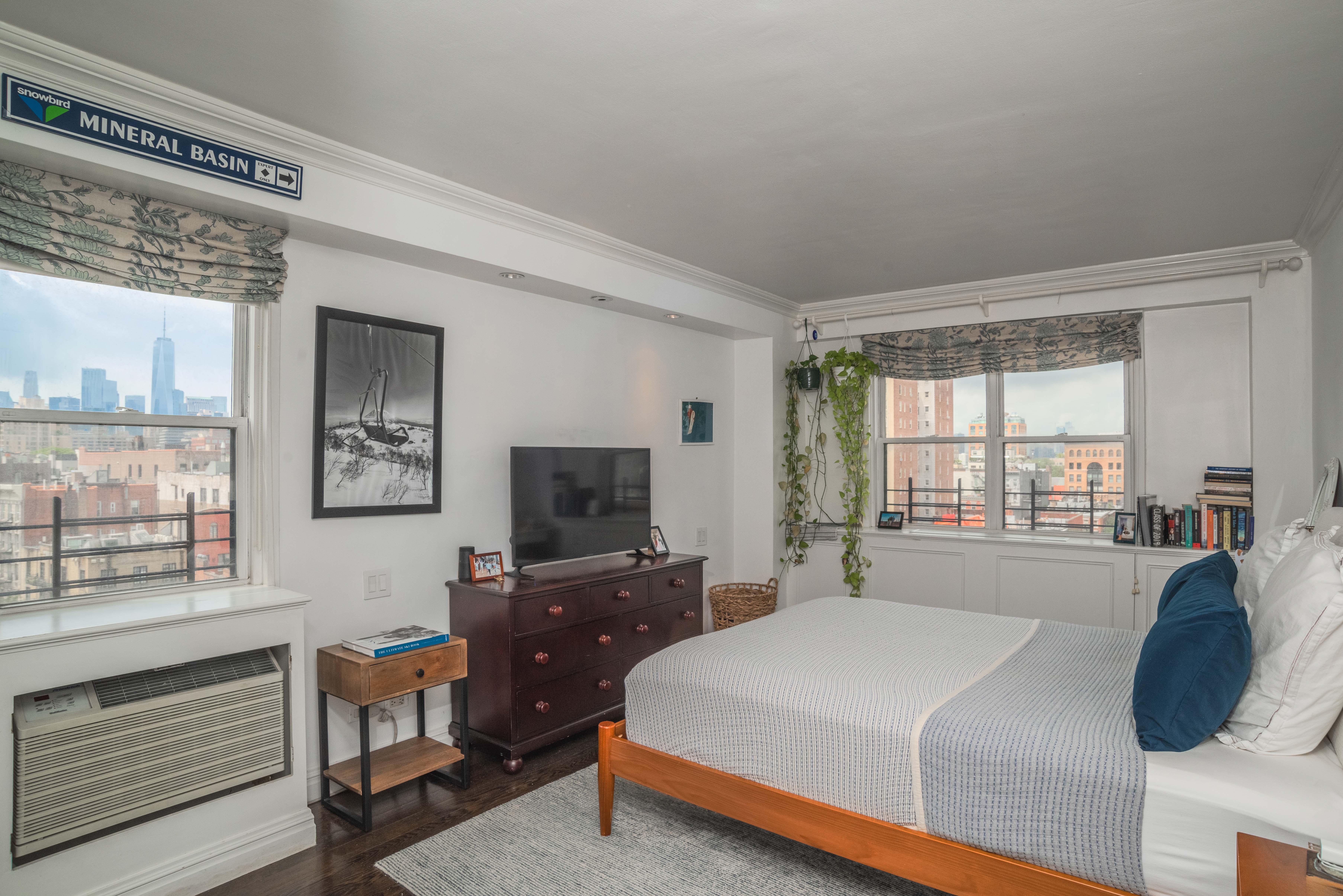31 Jane Street, Unit 9AB Manhattan, NY 10014 - Photo 5 of 14 a bedroom with a bed and a flat screen tv