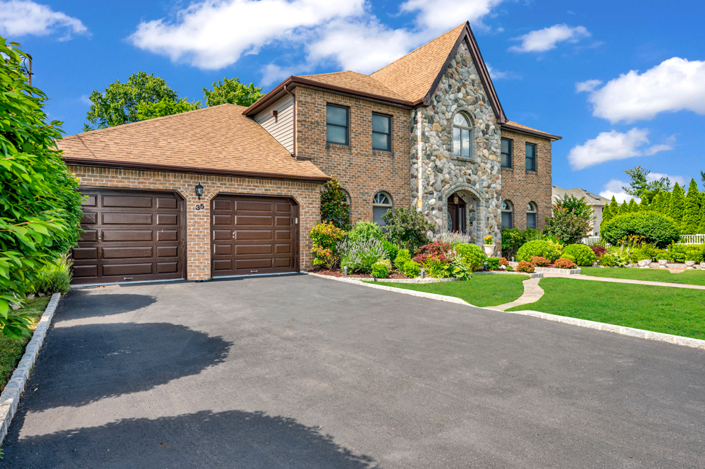 35 Poe Street Staten Island, NY 10307 - Photo 3 of 36 a front view of a house with a yard and garage