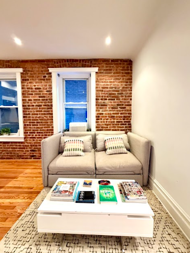 223 East 50th Street, Unit 1C Manhattan, NY 10022 - Photo 2 of 10 a bed room with a bed and a chair