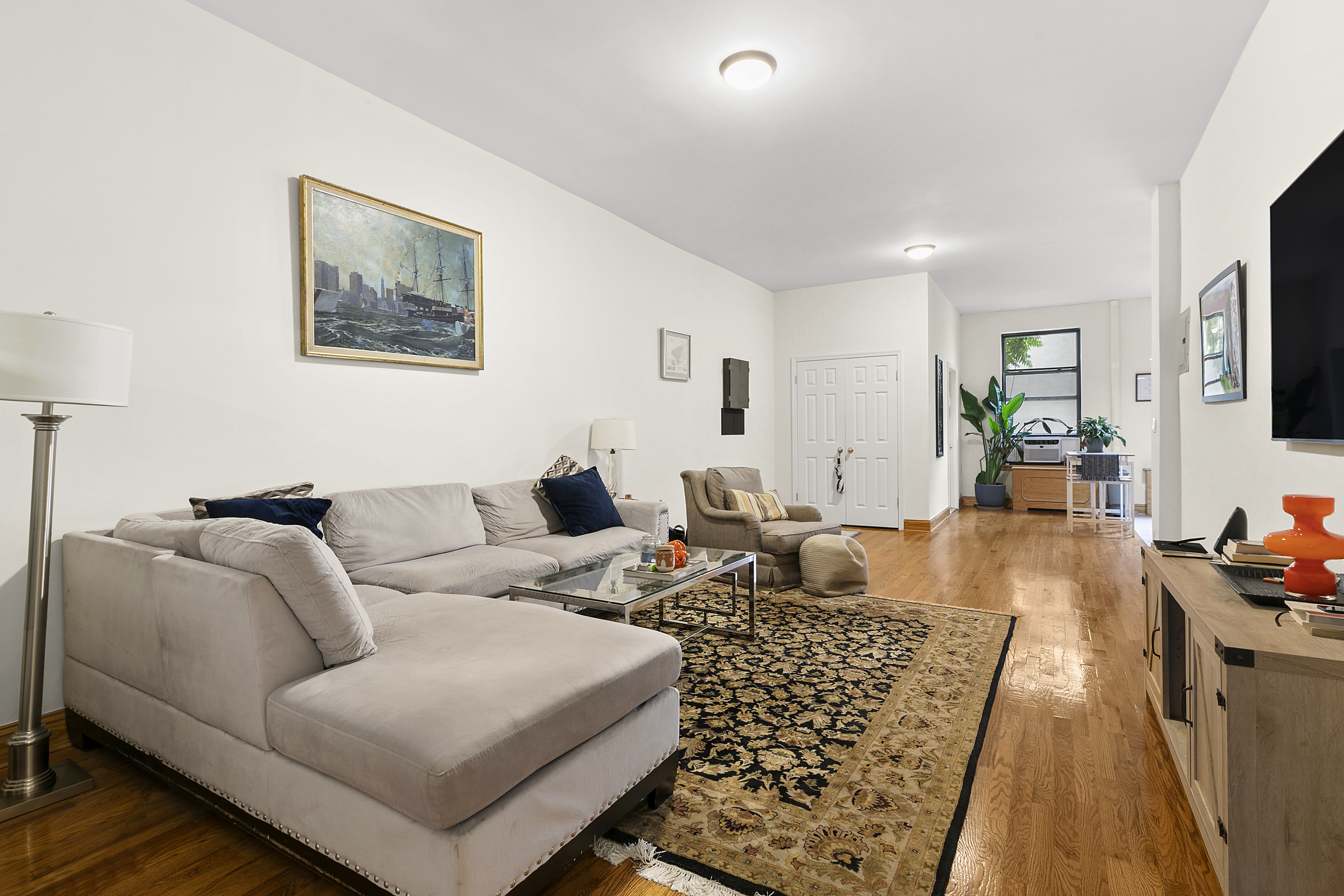 548 1/2 Hudson Street, Unit 2 Manhattan, NY 10014 - Photo 3 of 6 a living room with furniture and a couch