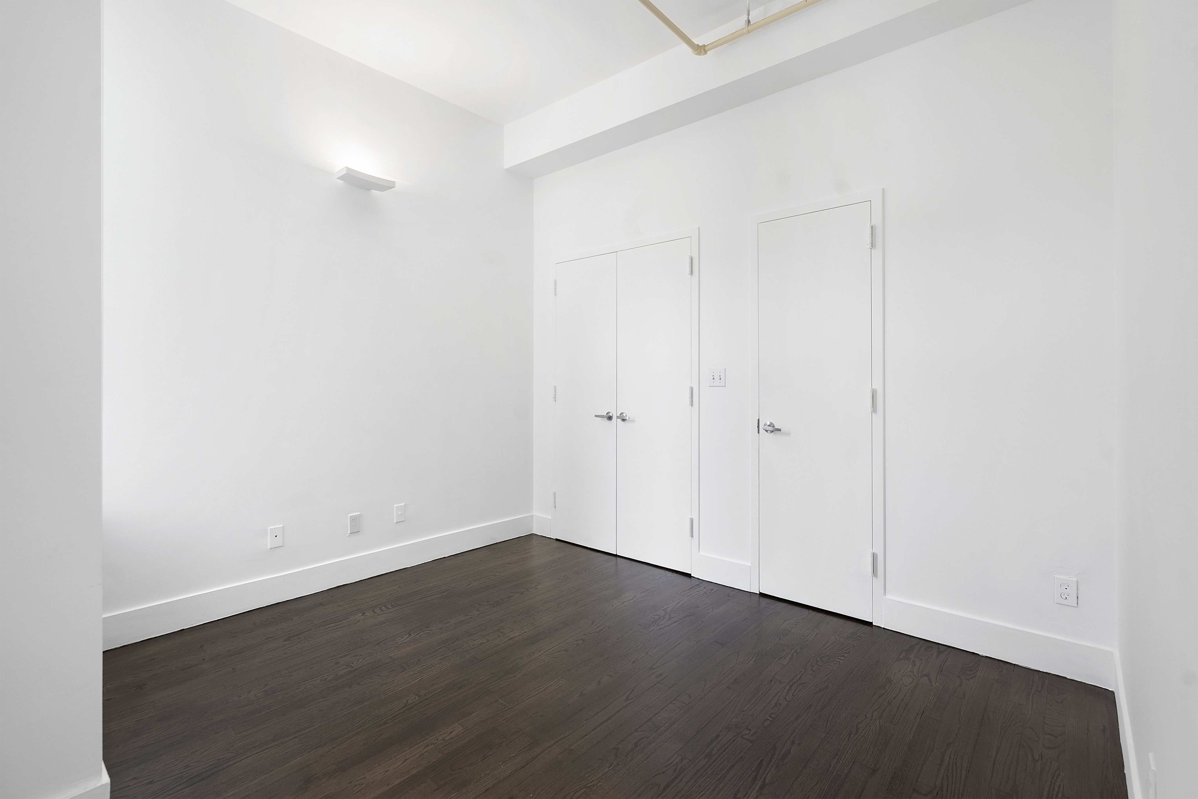 91 Grand Avenue, Unit 2D Brooklyn, NY 11205 - Photo 11 of 16 an empty room with wooden floor