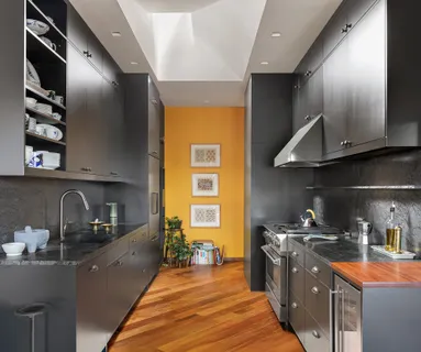 a kitchen with stainless steel appliances granite countertop a sink and wooden cabinets