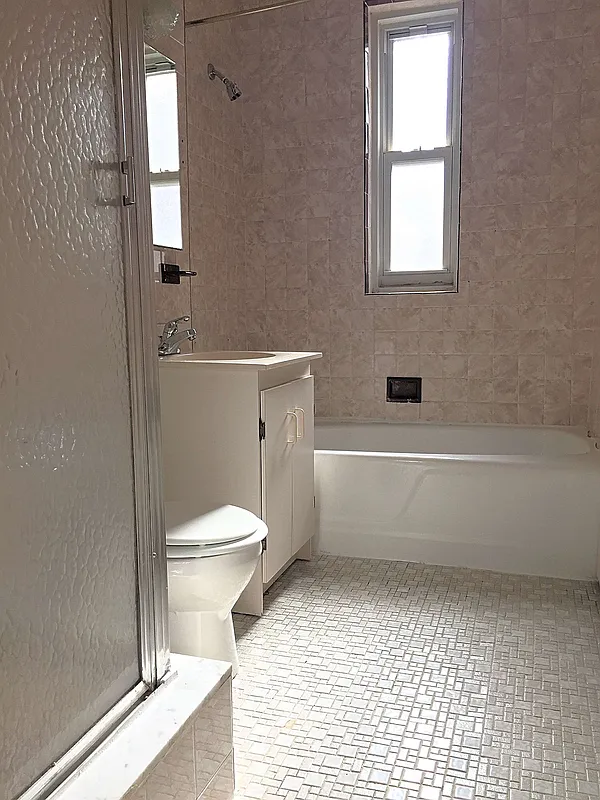 68-64 Yellowstone Boulevard, Unit B36 Queens, NY 11375 - Photo 4 of 4 a bathroom with a toilet a sink and a bathtub