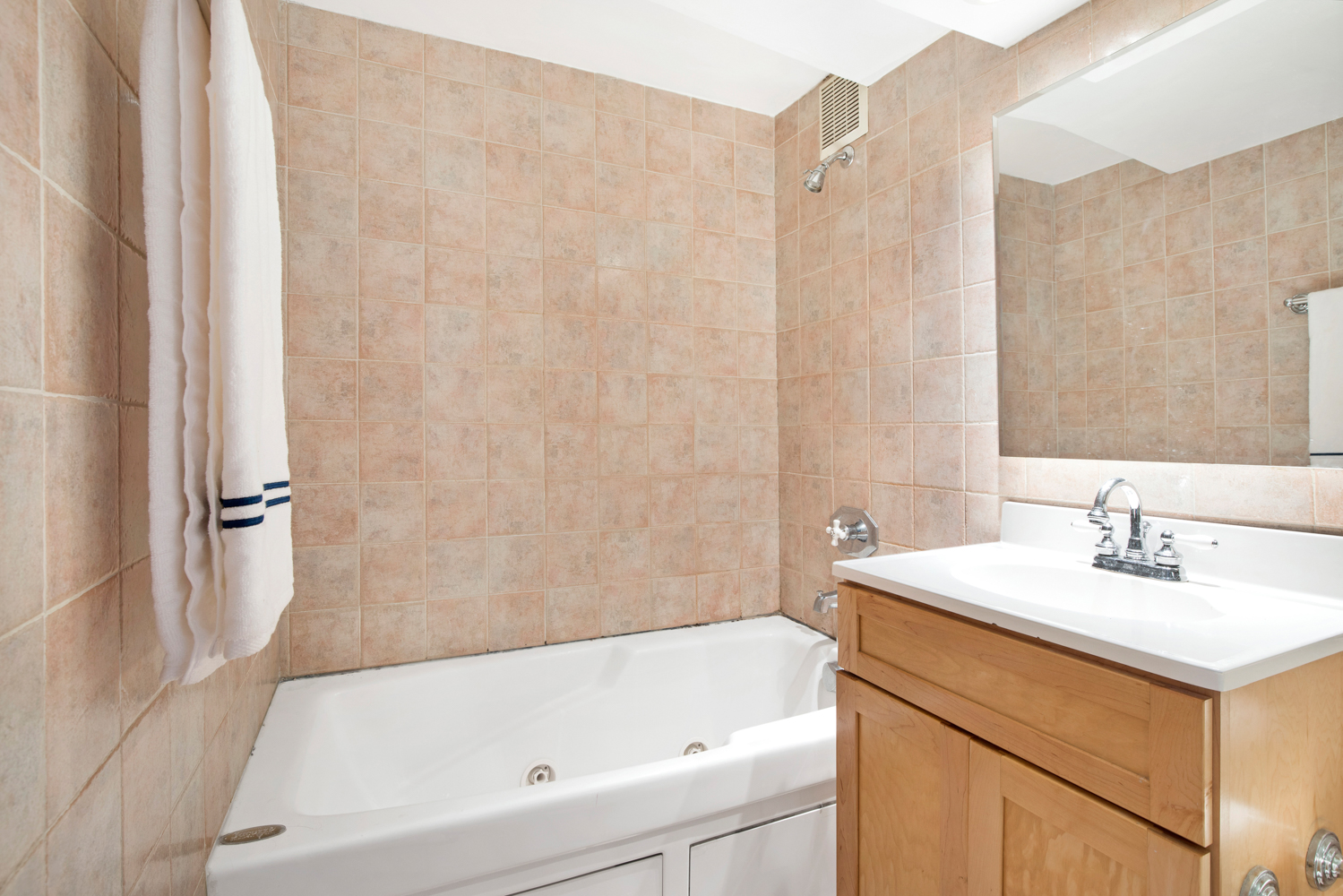 40 West 76th Street, Unit 10 Manhattan, NY 10023 - Photo 5 of 7 a bathroom with a sink mirror and a bathtub