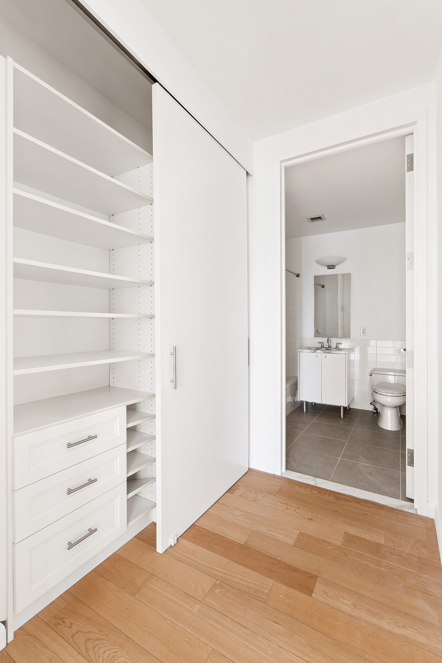 46-30 Center Boulevard, Unit PH8 Queens, NY 11109 - Photo 17 of 32 a view of a bedroom with closet and cabinet