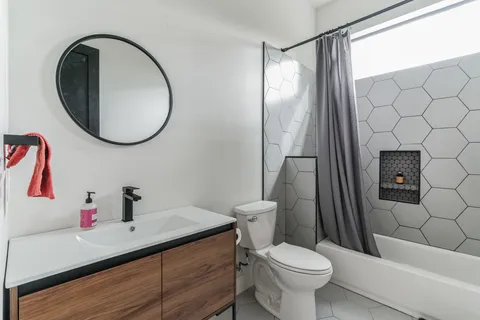 a bathroom with a sink toilet and a mirror