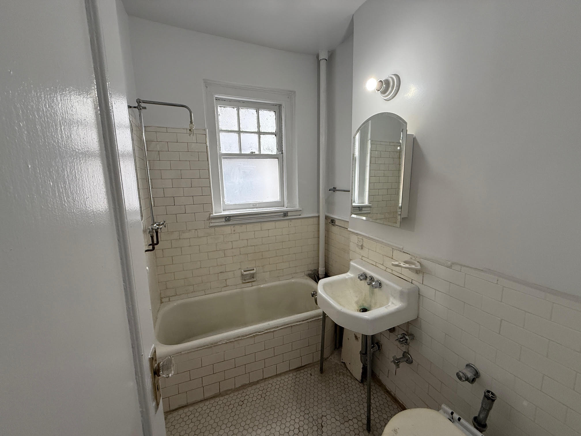 370 Central Park West, Unit 413 Manhattan, NY 10025 - Photo 12 of 19 a bathroom with a sink bathtub and a toilet