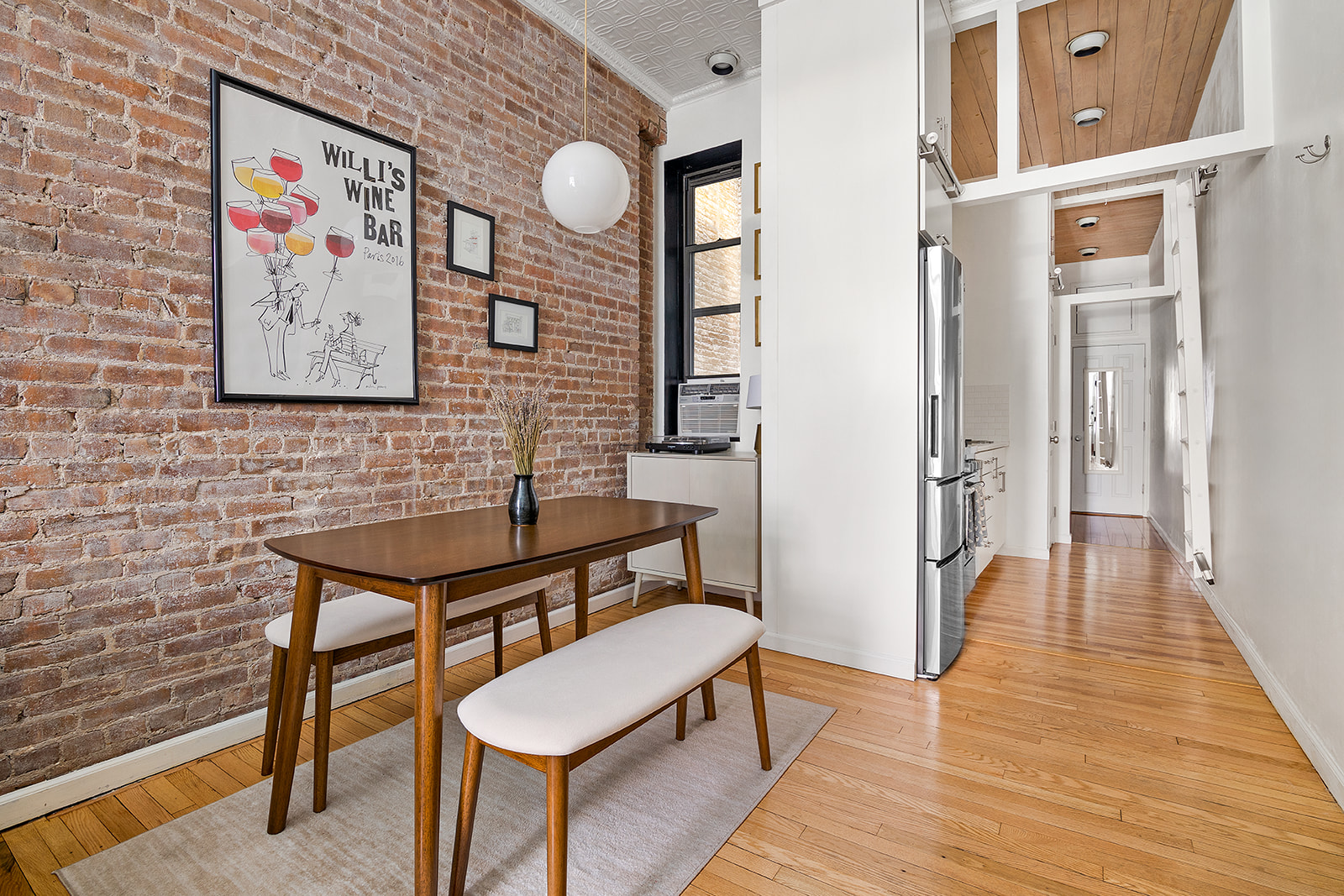 521 East 83rd Street, Unit 1W Manhattan, NY 10028 - Photo 2 of 7 a view of a hallway with wooden floor and furniture