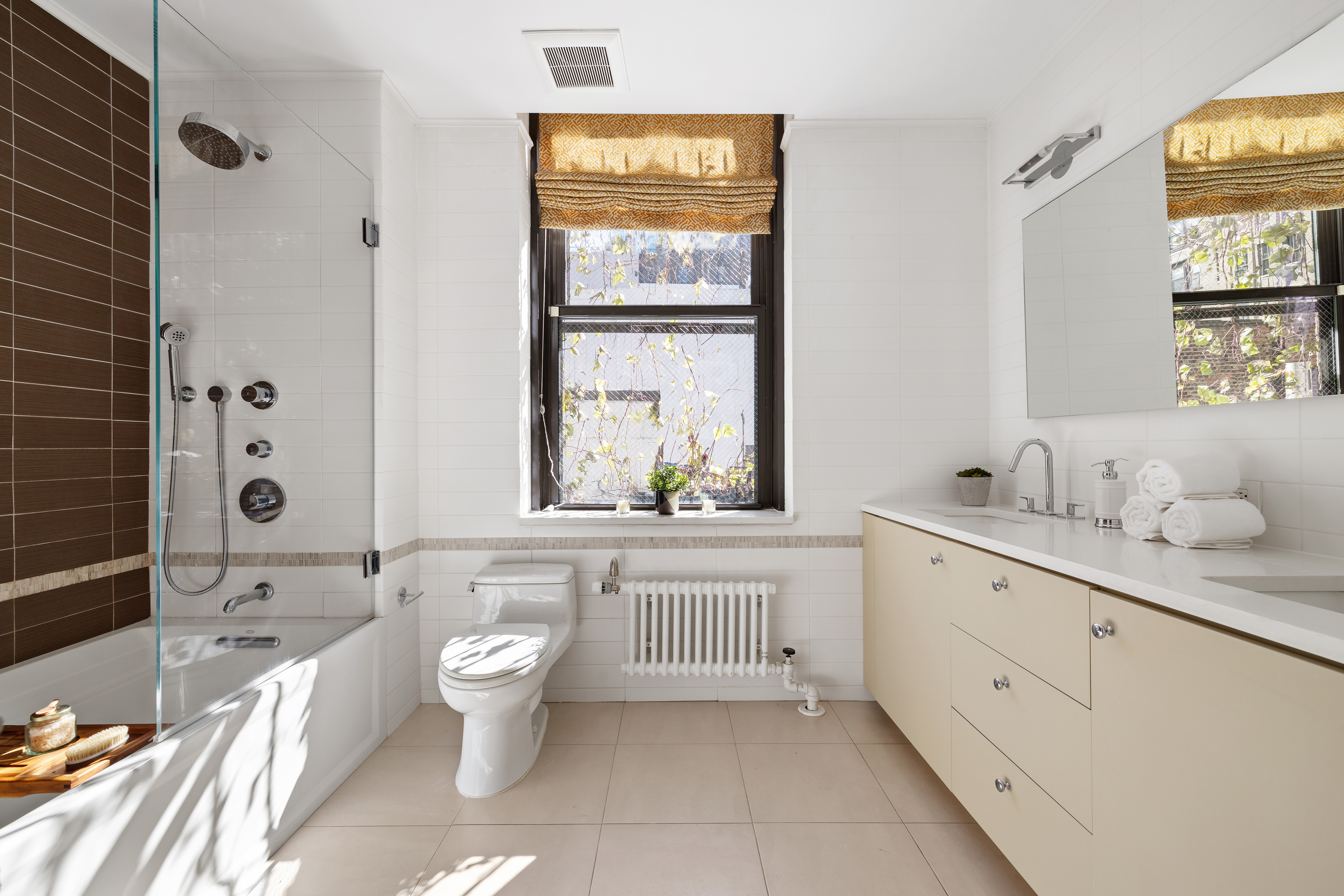 24 West 30th Street, Unit 6 Manhattan, NY 10001 - Photo 11 of 14 a bathroom with a granite countertop sink mirror vanity bathtub and toilet