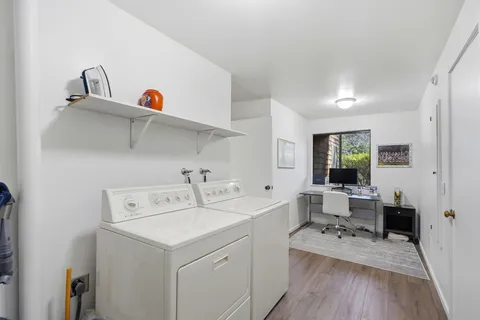 a view of washer and dryer with kitchen in the background