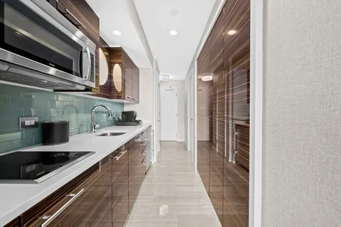 a kitchen with stainless steel appliances a stove and a microwave