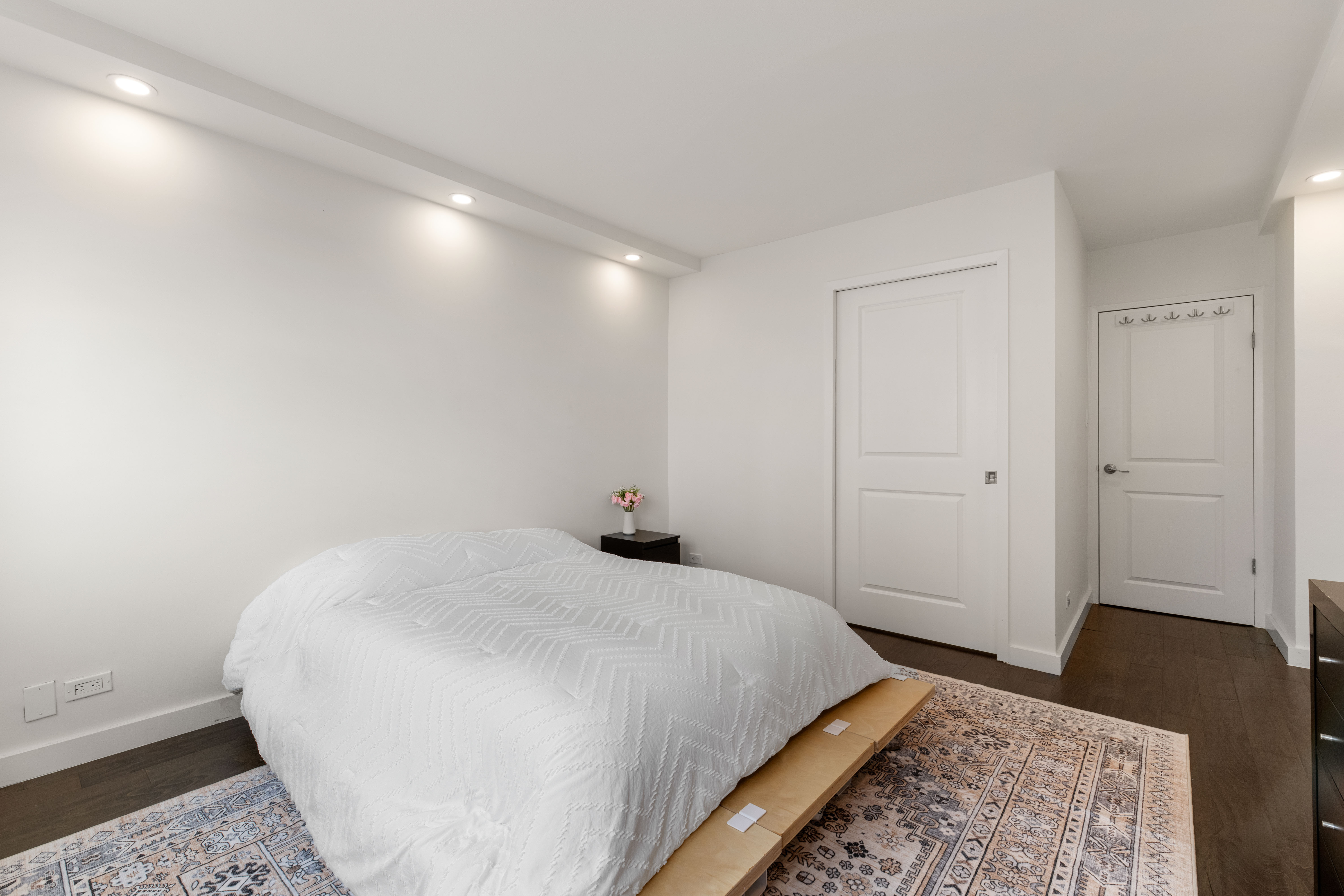 66-36 Yellowstone Boulevard, Unit 24A Queens, NY 11375 - Photo 10 of 20 a bedroom with a bed and wooden floor