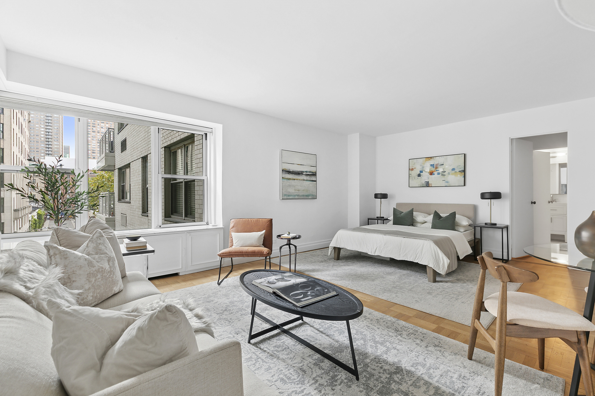 2 5th Avenue, Unit 5B Manhattan, NY 10011 - Photo 2 of 12 a living room with furniture and a potted plant