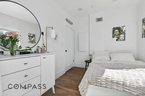 a bedroom with a large bed and a dresser