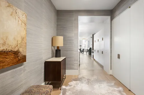 a hallway with a view of living room